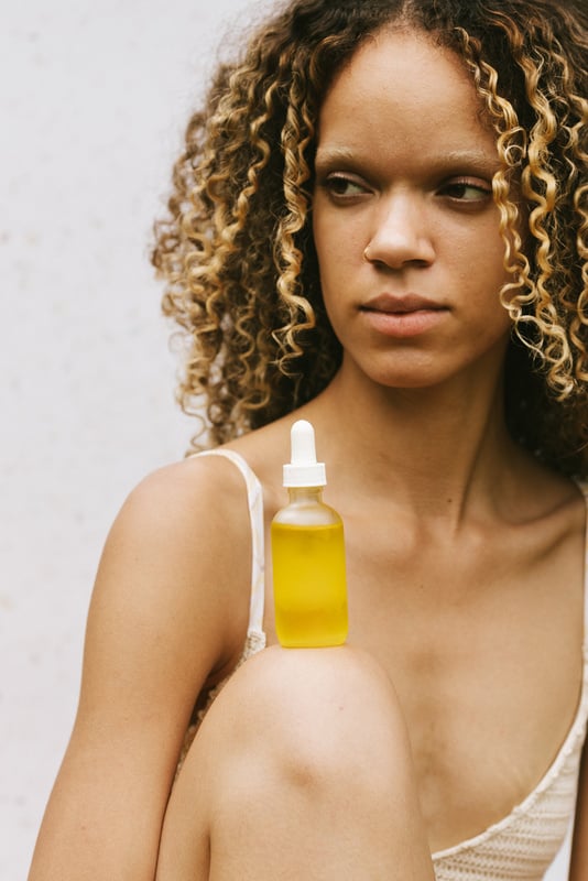 Portrait of a Woman with Bottle of Serum